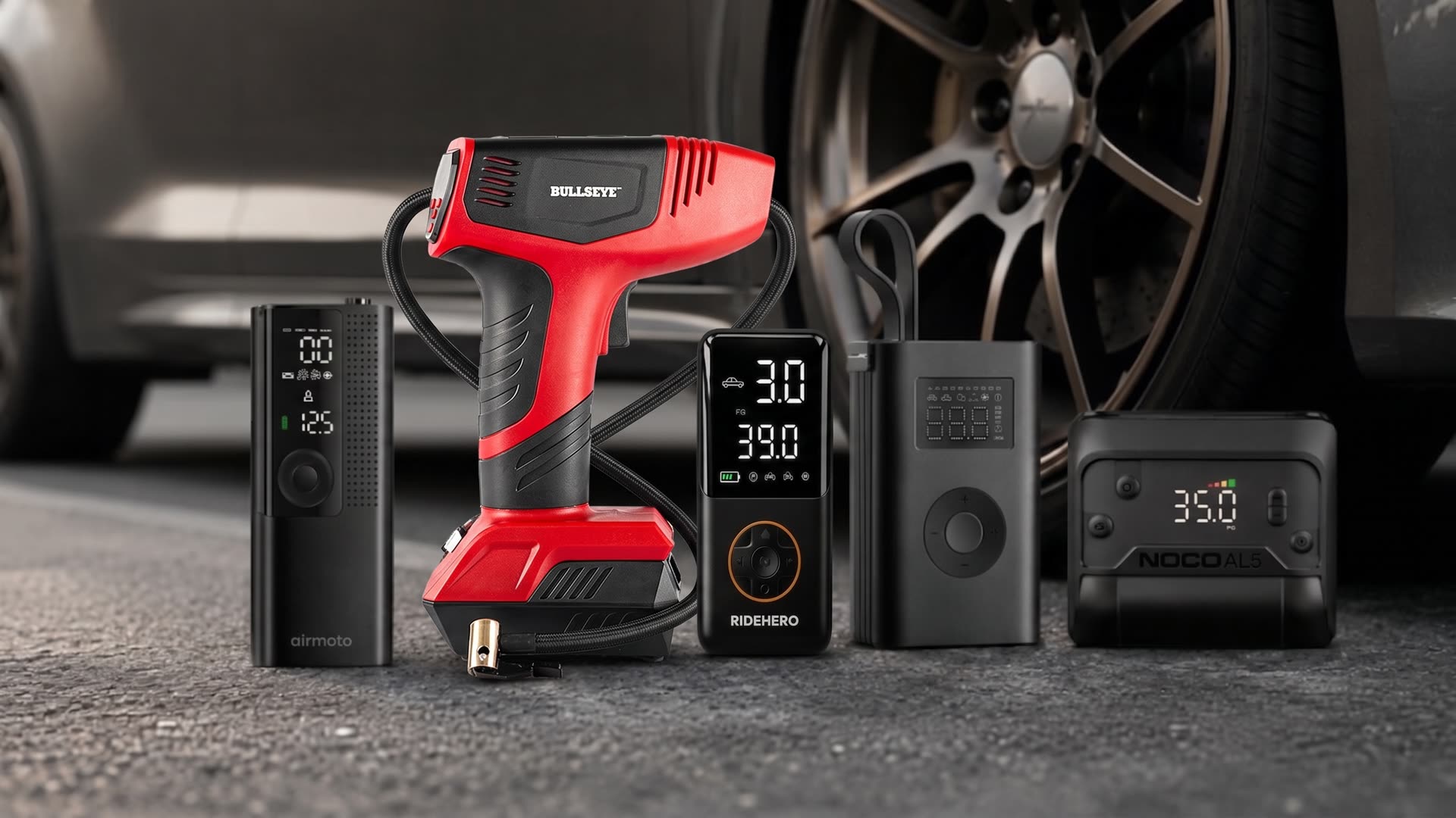 Portable tire inflators lined up next to a car wheel